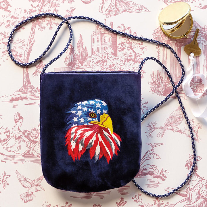 Monticello Embroidered Eagle Crossbody Bag on pink background - Monticello Shop